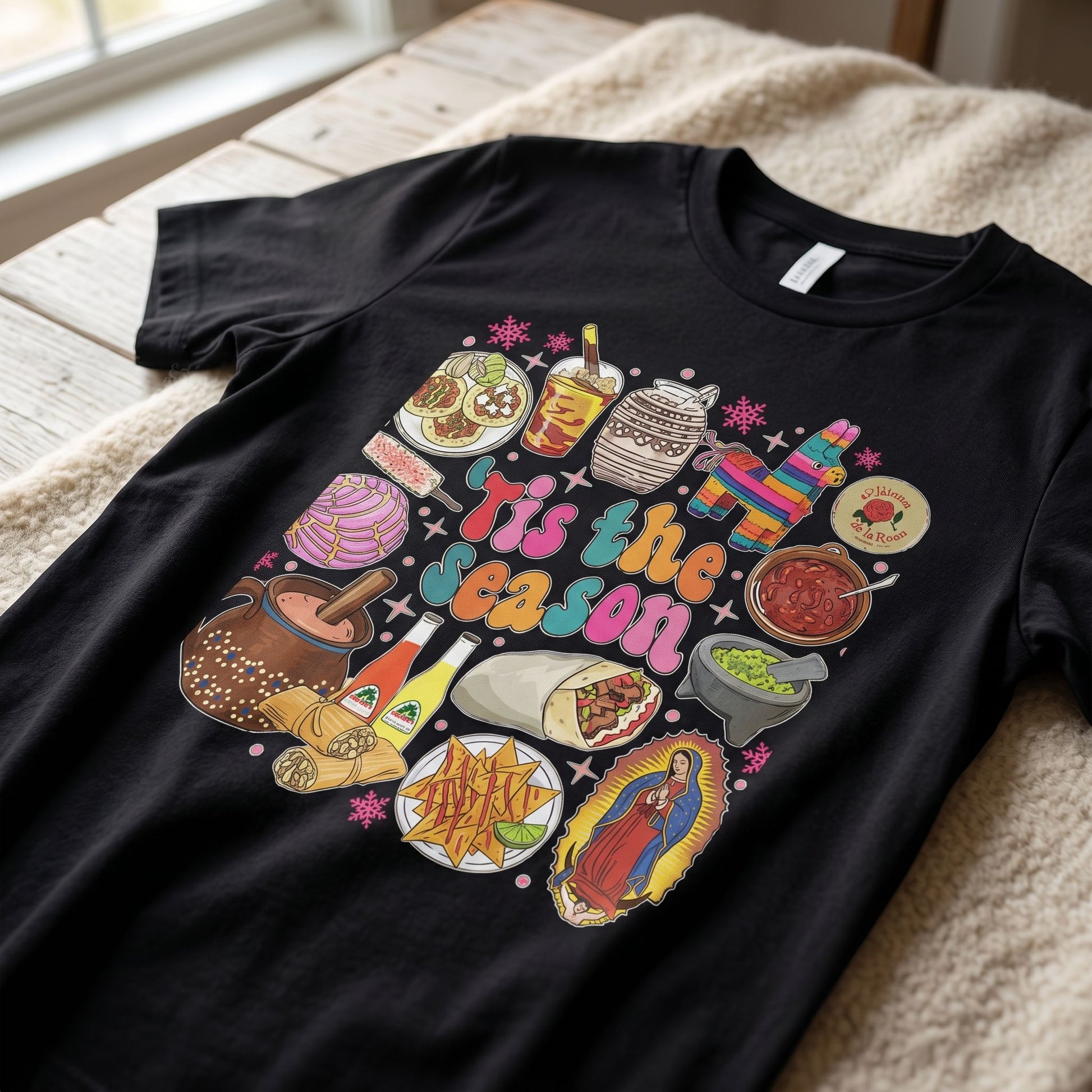 Close-up of soft cotton fabric texture of 'Tis the Season' t-shirt, highlighting the cozy material and festive design.
