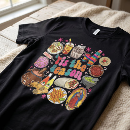 Close-up of soft cotton fabric texture of 'Tis the Season' t-shirt, highlighting the cozy material and festive design.